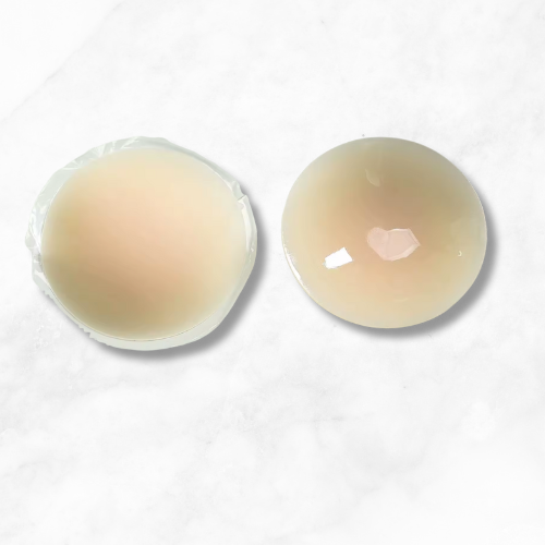 Close-up of smooth, skin-toned silicone nipple covers with textured edges and discreet adhesion surface for seamless wear.